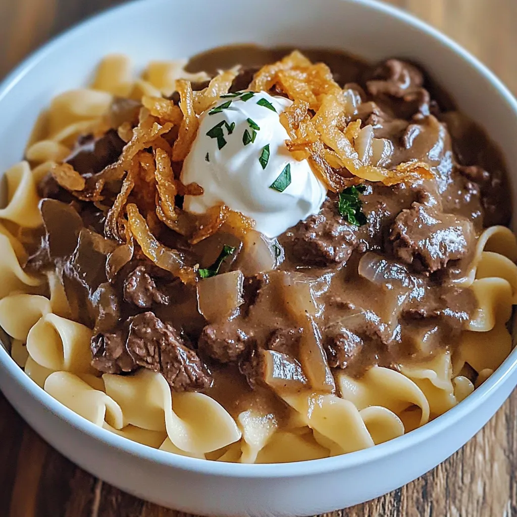 A bowl of pasta with meat and cheese.