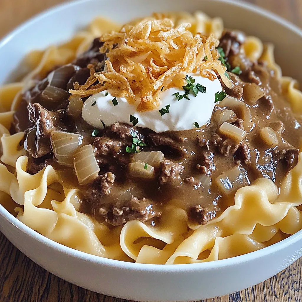 A bowl of food with onions and cheese on top.