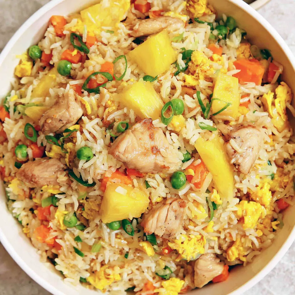 A bowl of chicken pineapple fried rice.