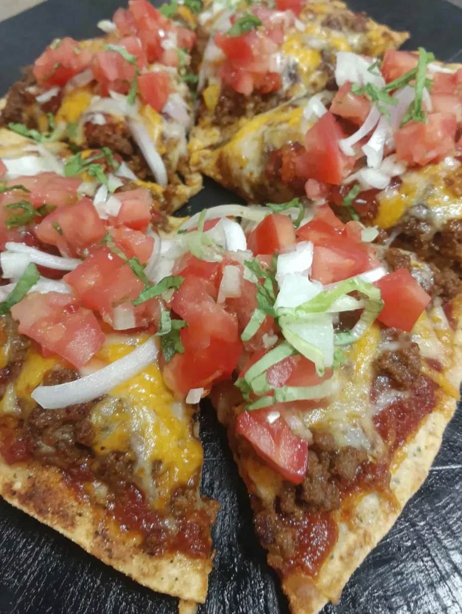 Two Mexican pizzas with tomatoes and onions.