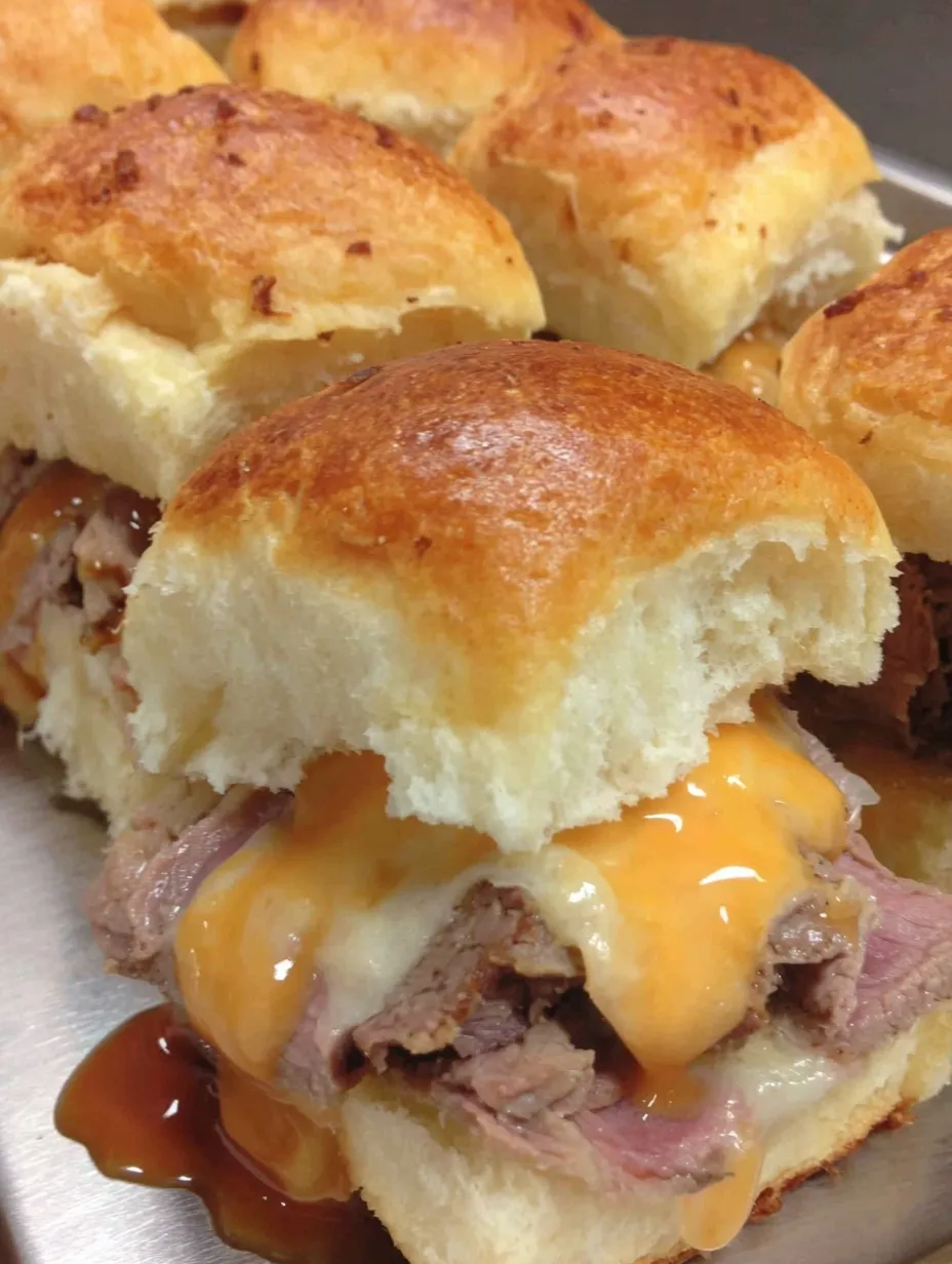 A plate of beef and cheddar sliders.