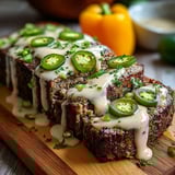 A slice of meat with jalapenos on it.