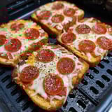 A slice of pizza on a grill.