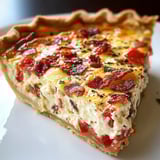 A slice of cheese and tomato pie.