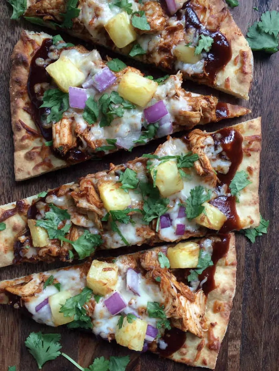 A flatbread with chicken and pineapple on it.