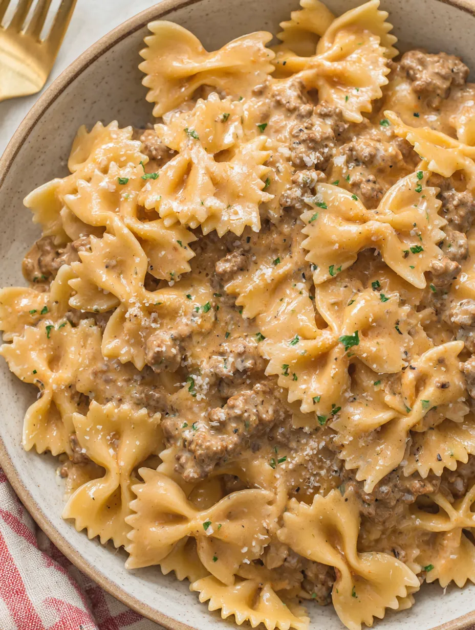 A bowl of creamy beef and bowtie pasta.