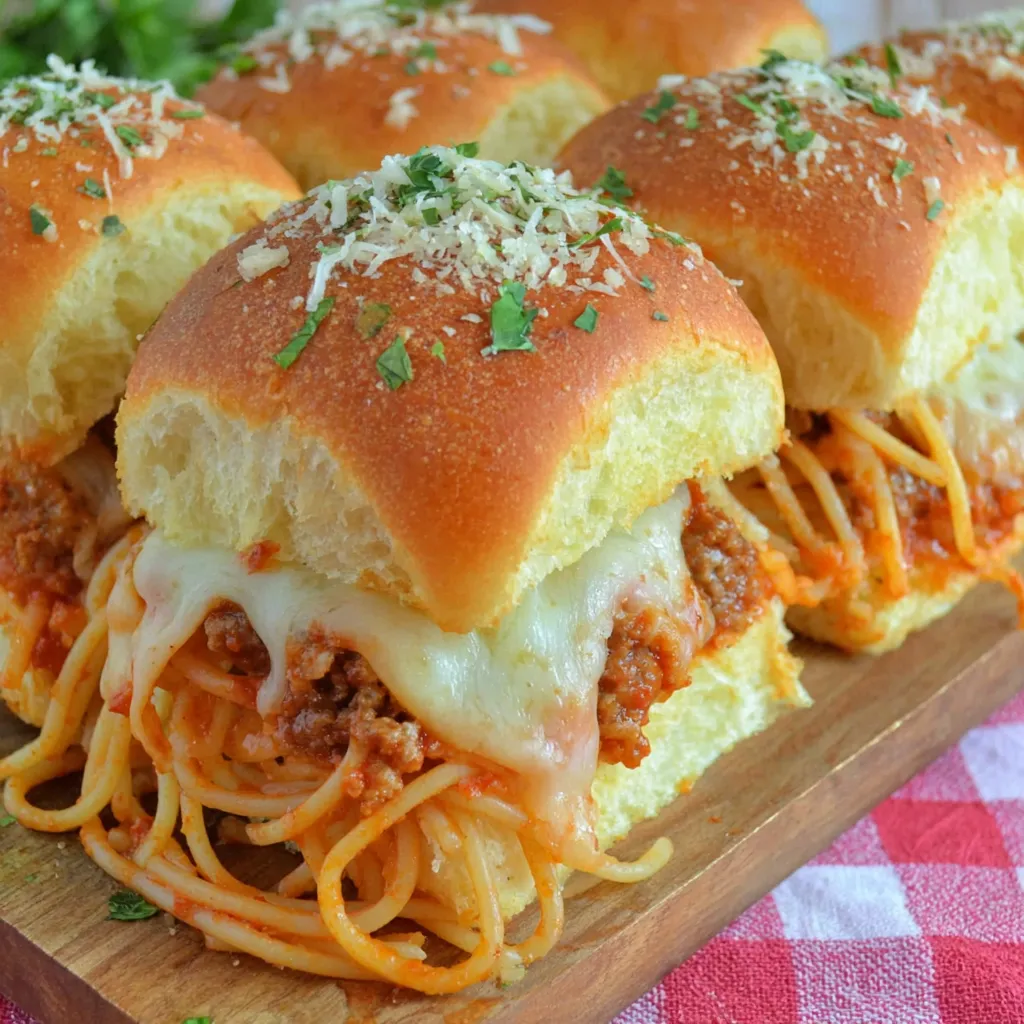 A plate of spaghetti sliders with cheese and meat.