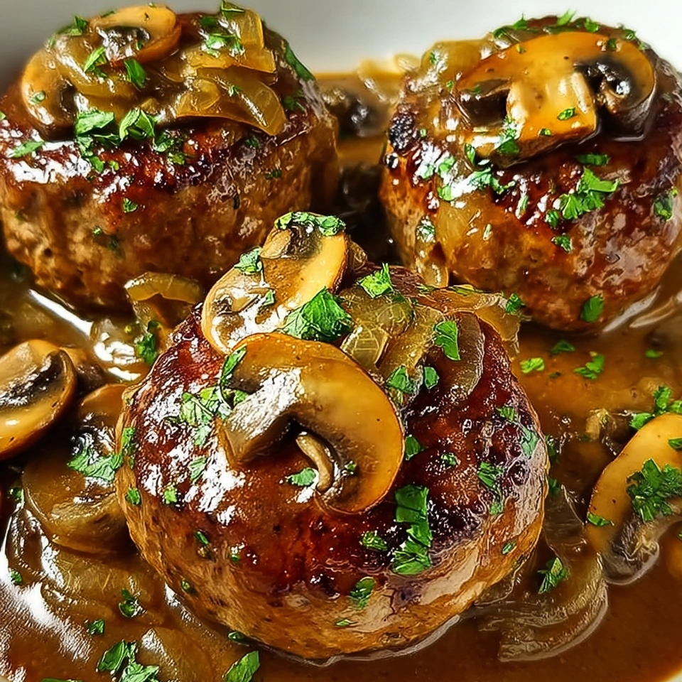 A plate of meat covered in mushrooms.