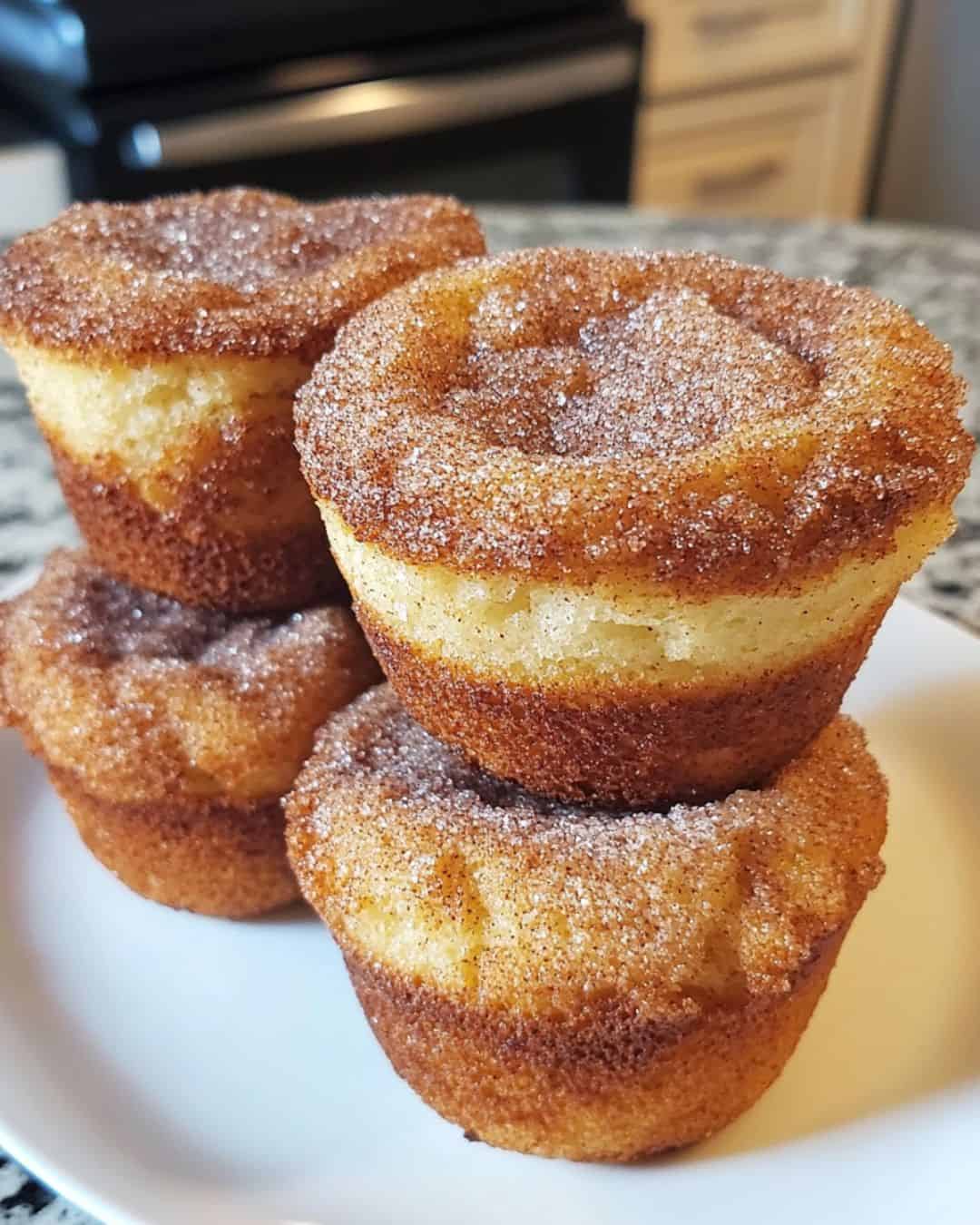 Three muffins with cinnamon sugar on top.