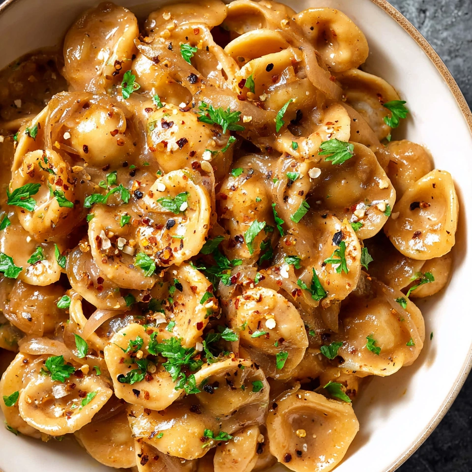 A bowl of pasta with a French onion sauce.