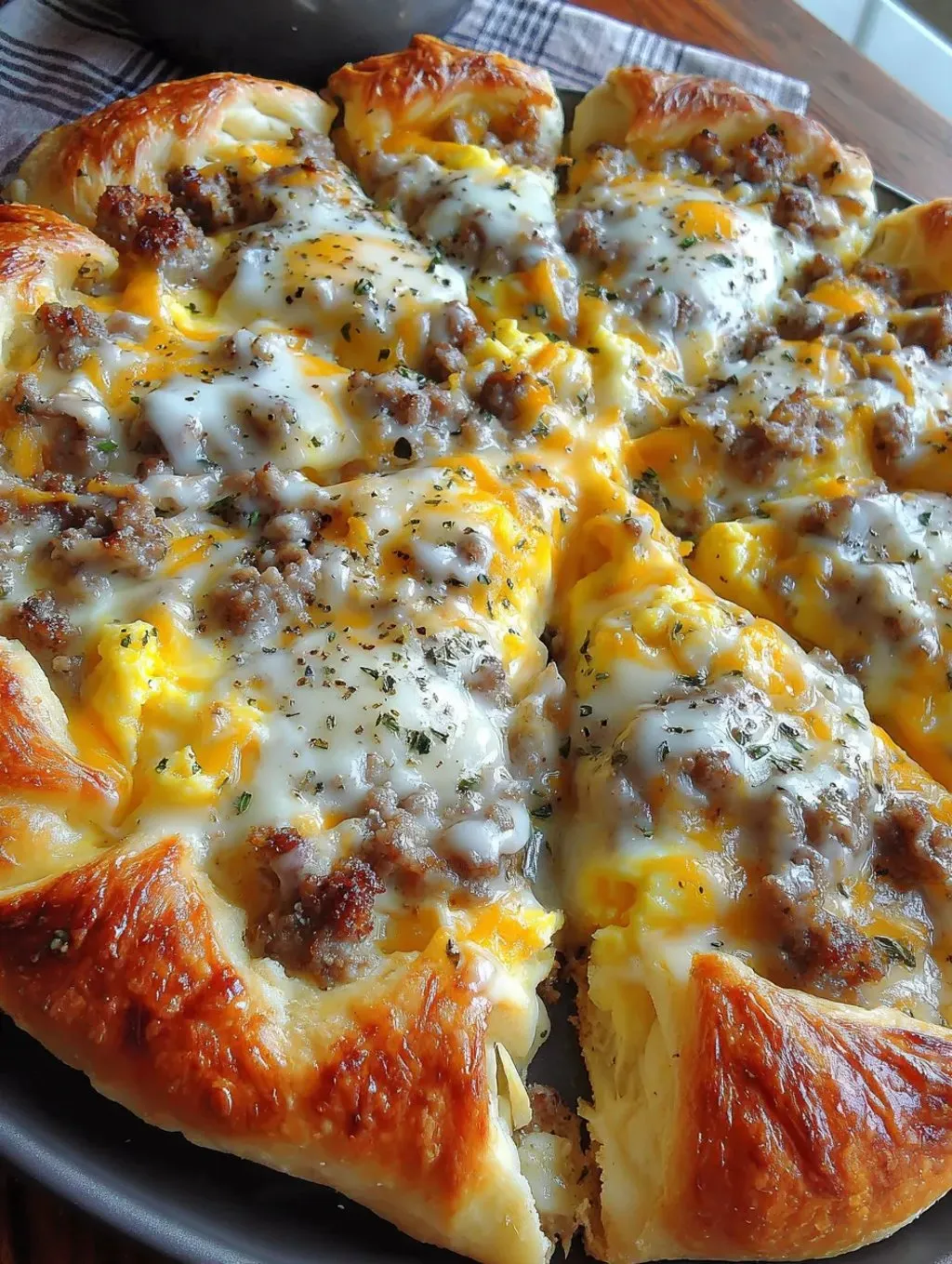 A slice of sausage gravy breakfast pizza.