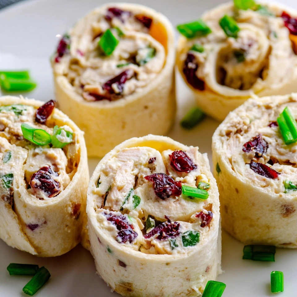 Creamy chicken cranberry pecan pinwheels.