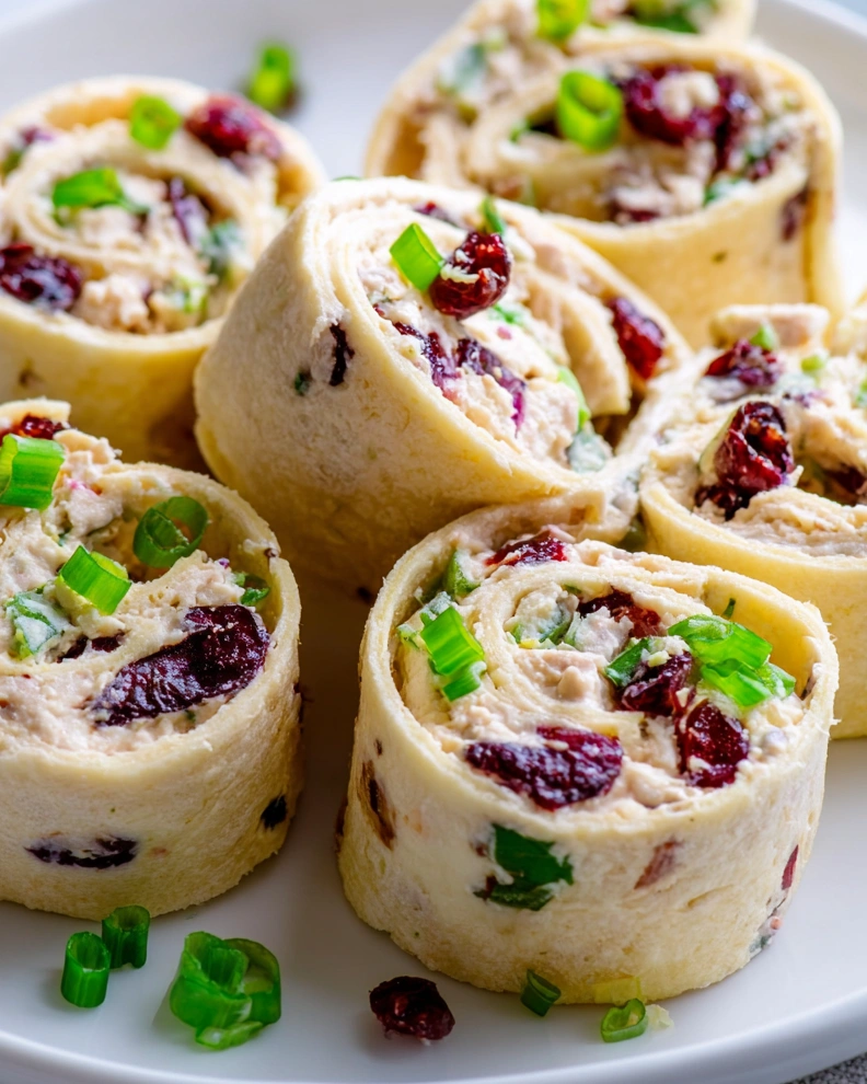 Creamy chicken cranberry pecan pinwheels.