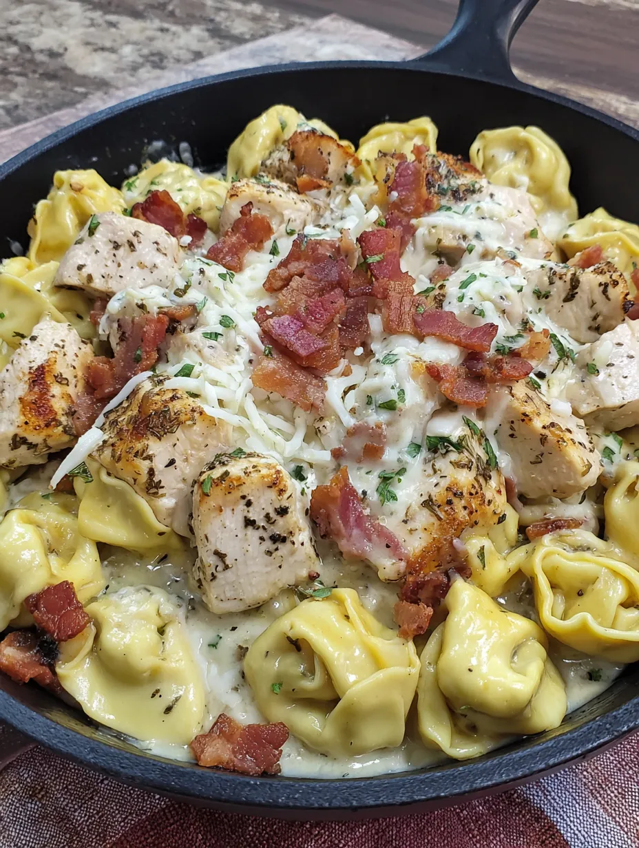 A dish of chicken alfredo tortellini.