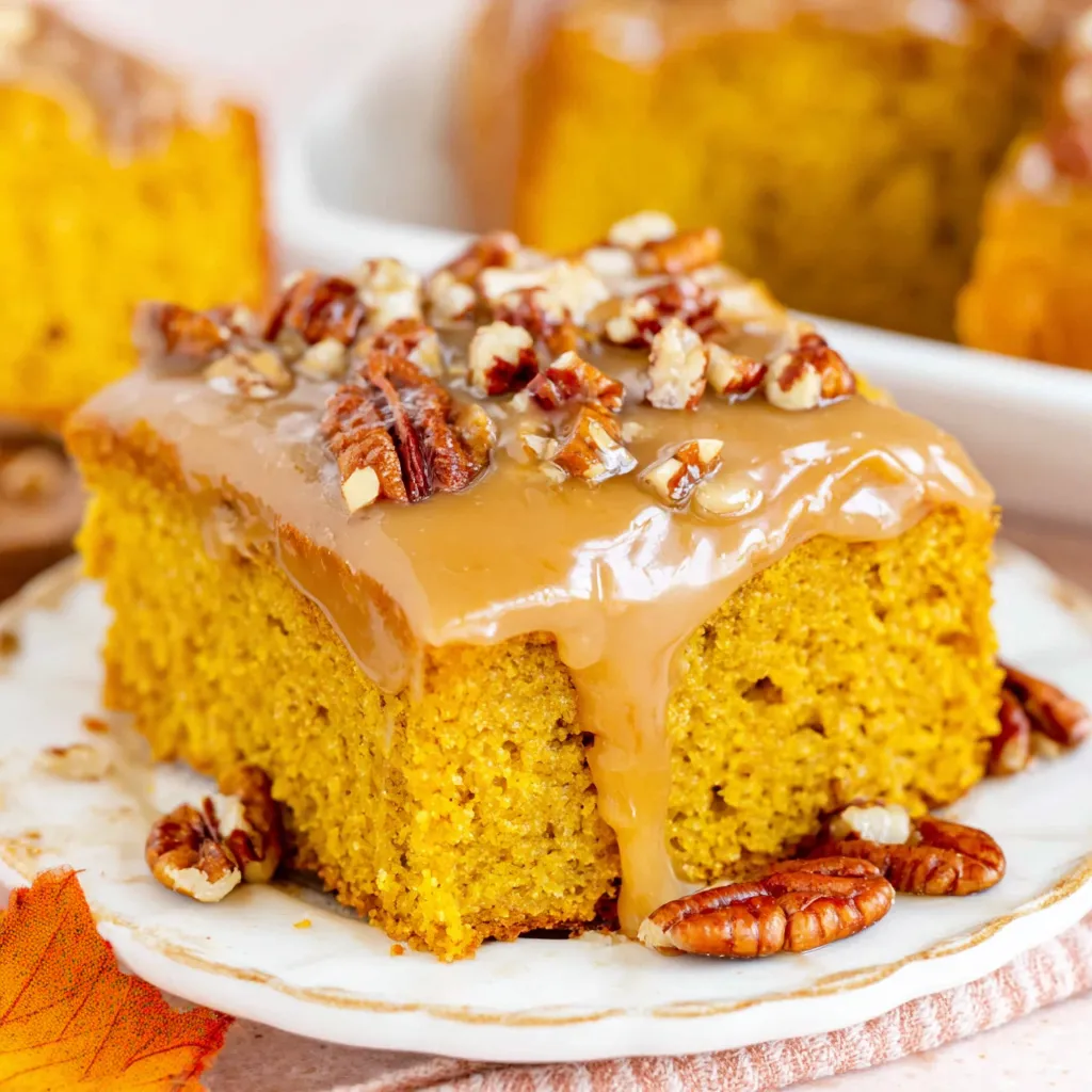 A slice of pumpkin snack cake with praline icing.