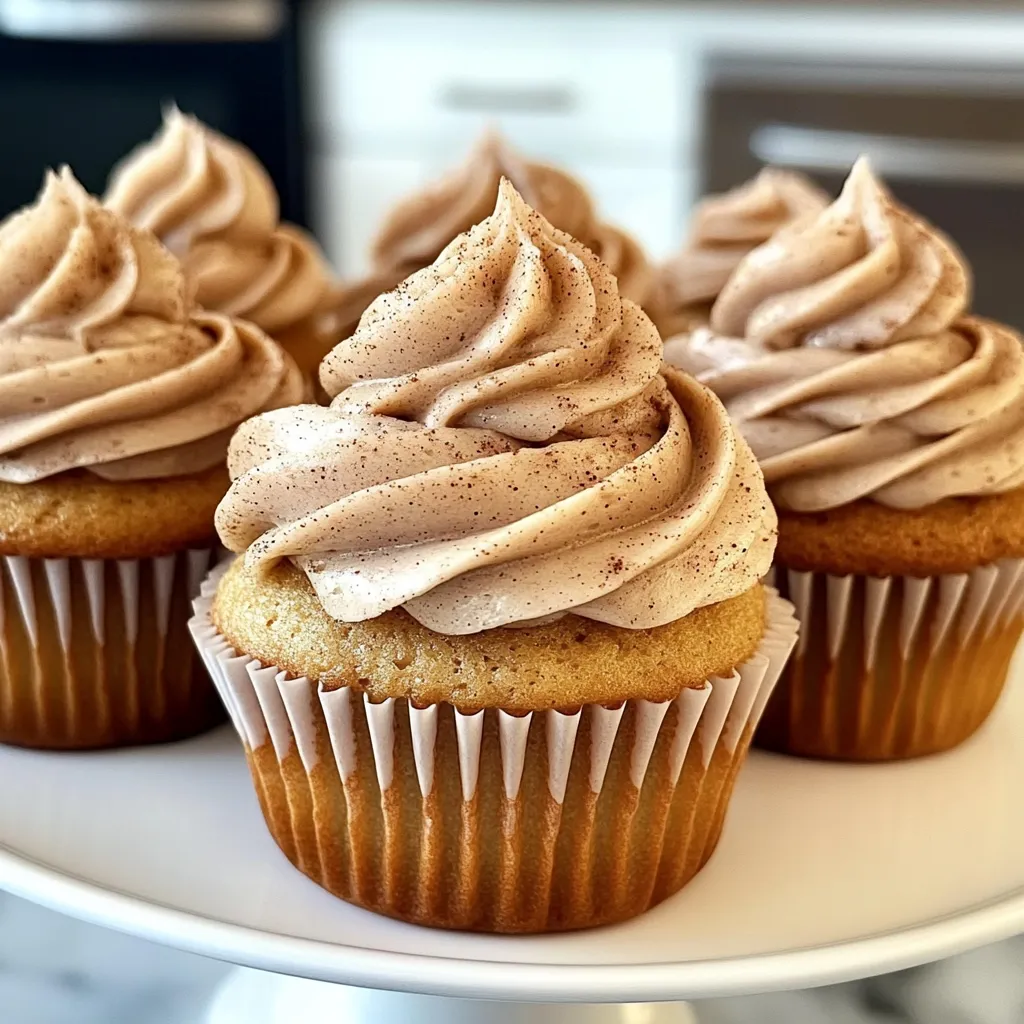 Three cupcakes with frosting and sprinkles.