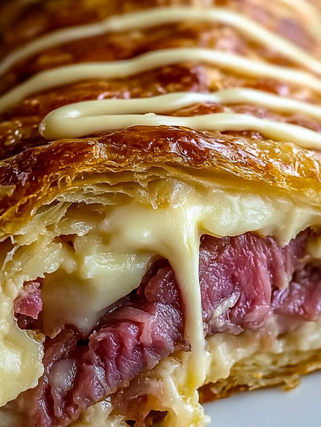 A slice of a Reuben Crescent Bake.