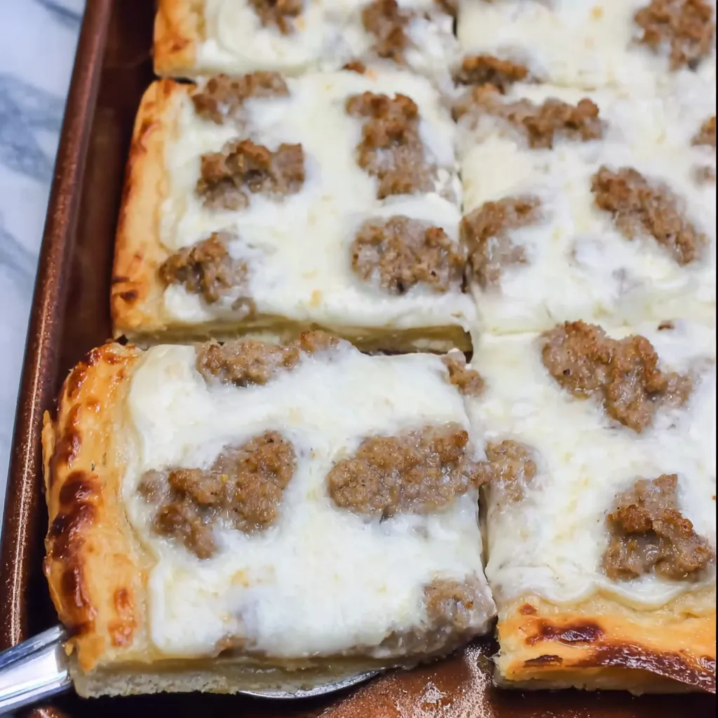 A slice of pizza with meat and cheese.