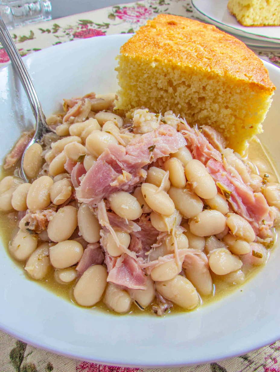 A bowl of slow cooker ham and white beans.