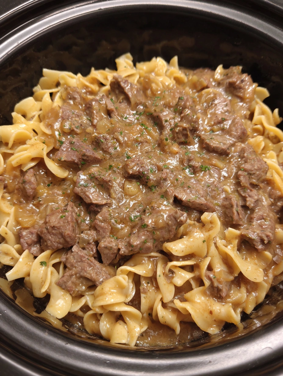 A bowl of beef and noodles in the crockpot.