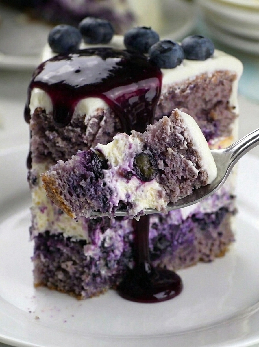 A slice of blueberry cheesecake cake.