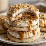 A stack of cookies with caramel drizzle on top.